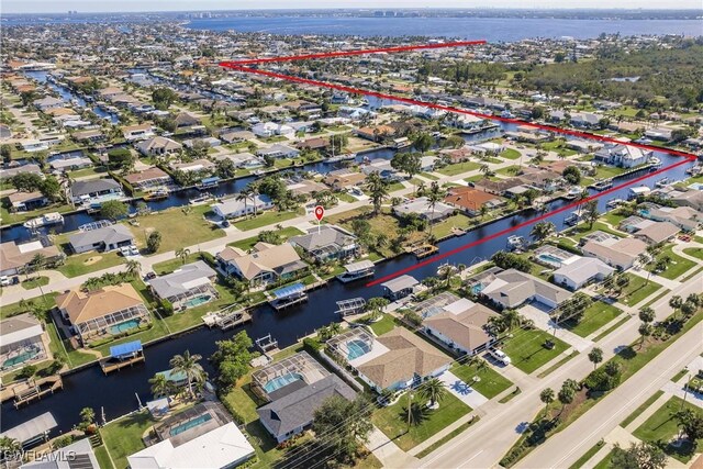 bird's eye view featuring a water view and a residential view