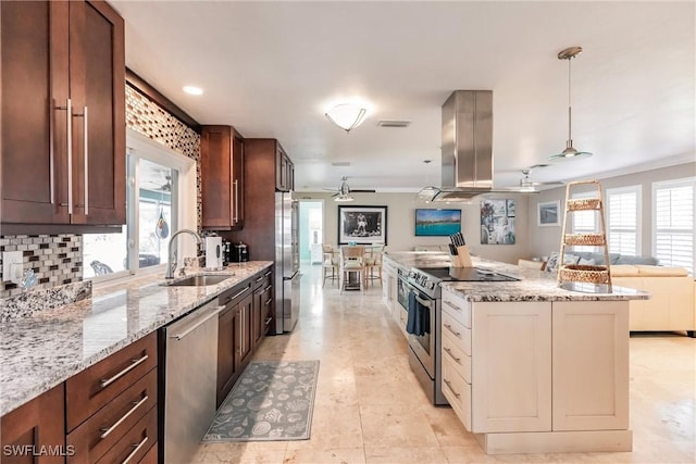 kitchen with island range hood, stainless steel appliances, a sink, a ceiling fan, and open floor plan