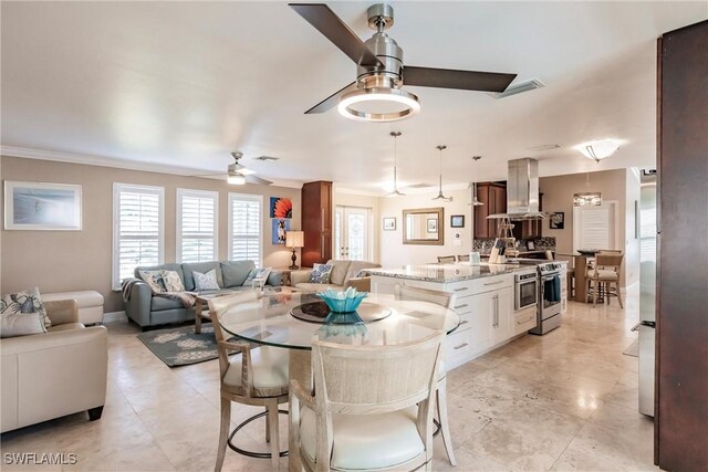 dining space featuring ornamental molding and ceiling fan