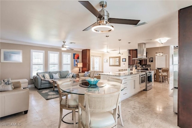 dining space featuring ceiling fan, ornamental molding, and visible vents