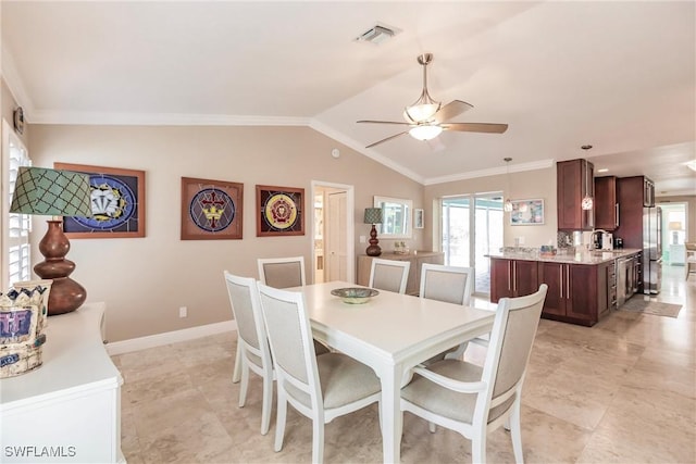 dining area with crown molding, visible vents, vaulted ceiling, and baseboards