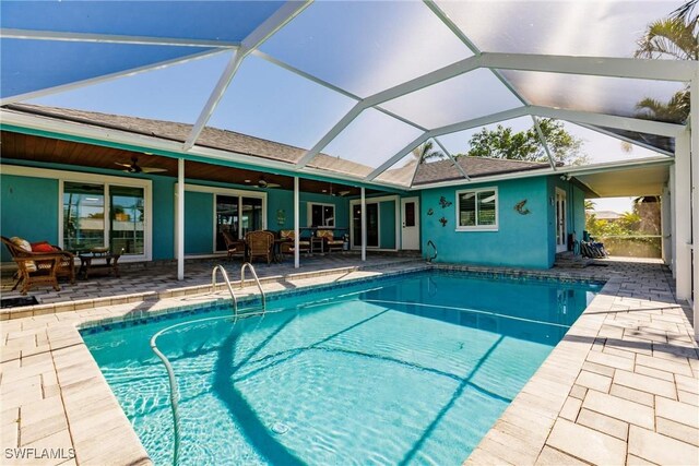 view of pool featuring a lanai, a patio area, and ceiling fan