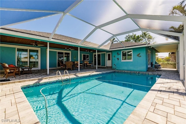 pool with a lanai, a patio area, and ceiling fan