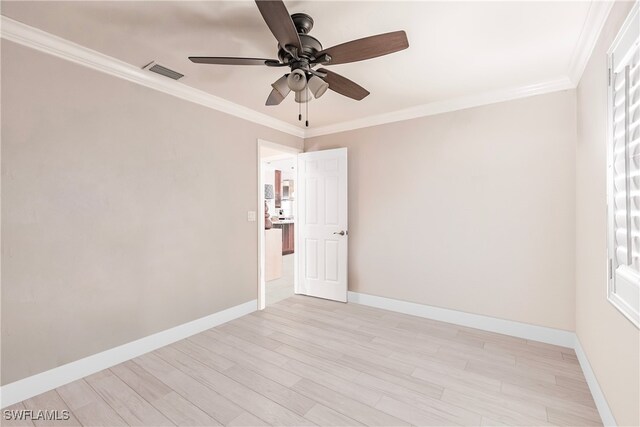 unfurnished room with baseboards, visible vents, light wood-style flooring, ceiling fan, and crown molding