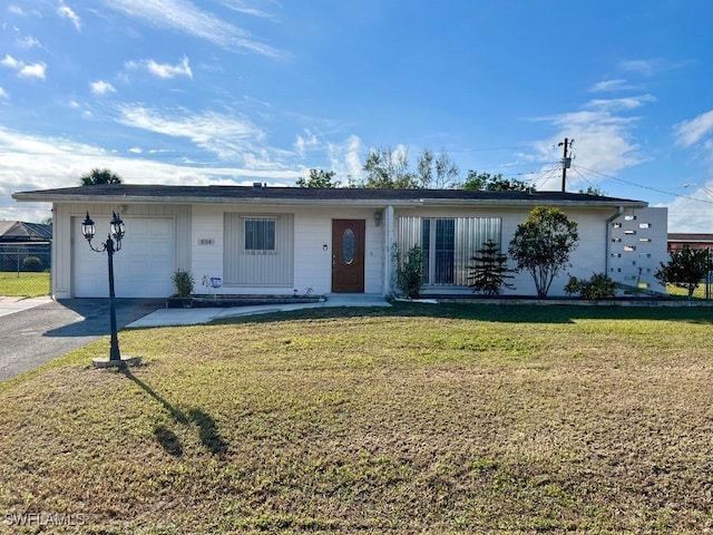 single story home with a front yard and a garage