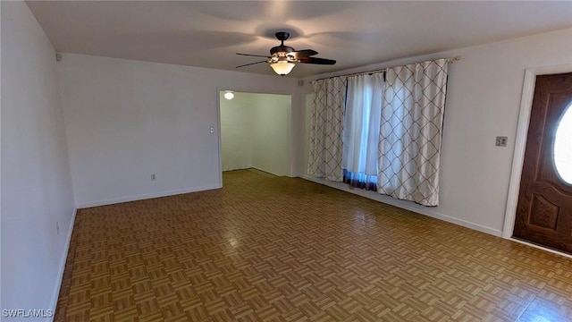 entrance foyer featuring parquet flooring and ceiling fan