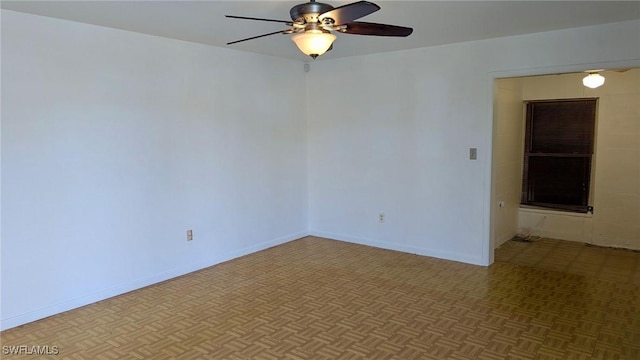 unfurnished room featuring ceiling fan and parquet flooring