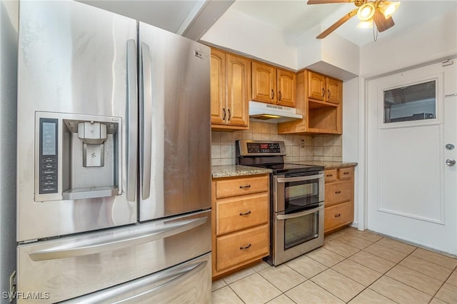 804 Bougainvillea Rd E, Lehigh Acres, FL 33936 - kitchen featuring appliances with stainless steel finishes, under cabinet range hood, backsplash, a ceiling fan, and light tile patterned floors