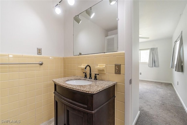 804 Bougainvillea Rd E, Lehigh Acres, FL 33936 - bathroom with vanity, tile walls, and wainscoting