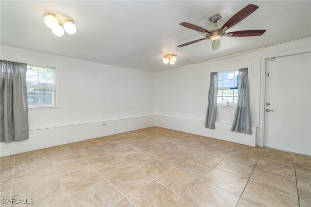 804 Bougainvillea Rd E, Lehigh Acres, FL 33936 - spare room featuring healthy amount of natural light and a ceiling fan