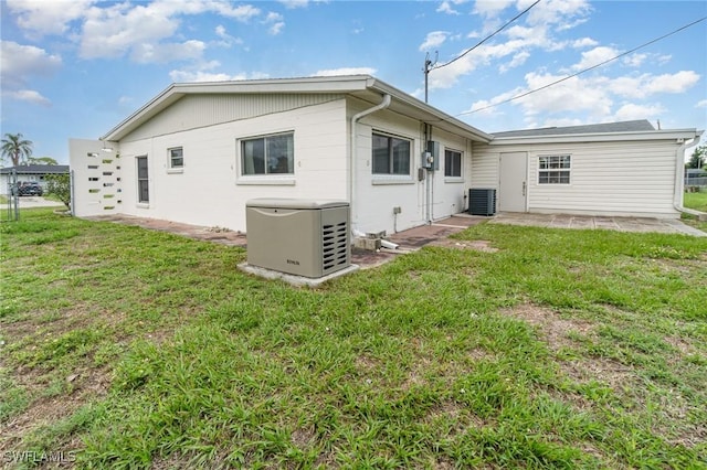 804 Bougainvillea Rd E, Lehigh Acres, FL 33936 - rear view of property featuring cooling unit, a yard, and a patio area
