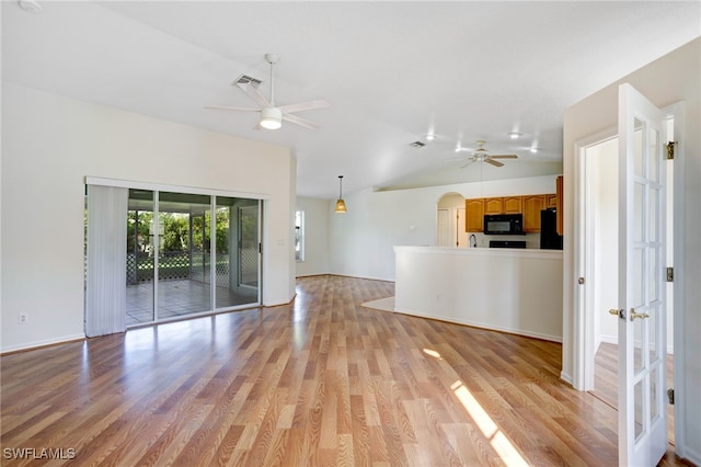 unfurnished living room with ceiling fan, light hardwood / wood-style flooring, and vaulted ceiling