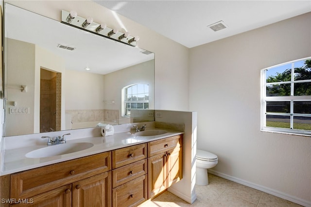 bathroom with tile patterned flooring, vanity, and toilet