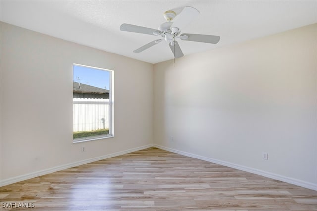 spare room featuring ceiling fan and light hardwood / wood-style flooring