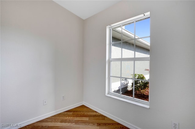 empty room with hardwood / wood-style flooring