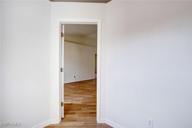 hallway with light hardwood / wood-style floors