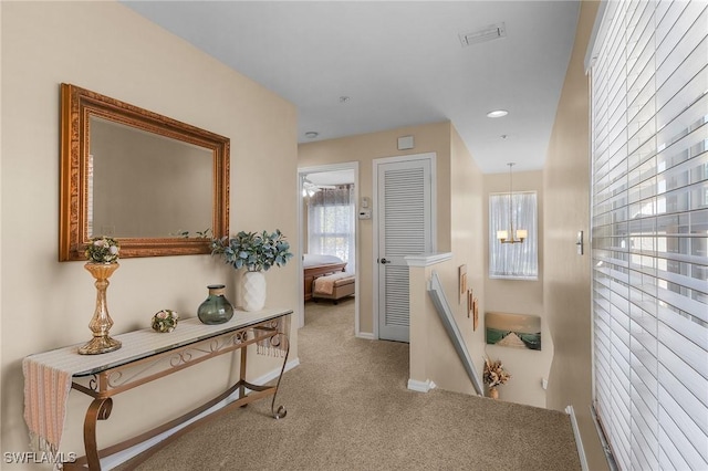 hallway with light colored carpet