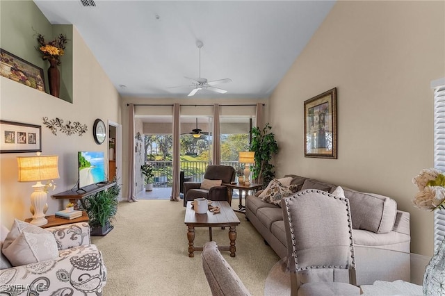 living room with light carpet, ceiling fan, and vaulted ceiling