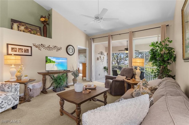 carpeted living room with ceiling fan and lofted ceiling