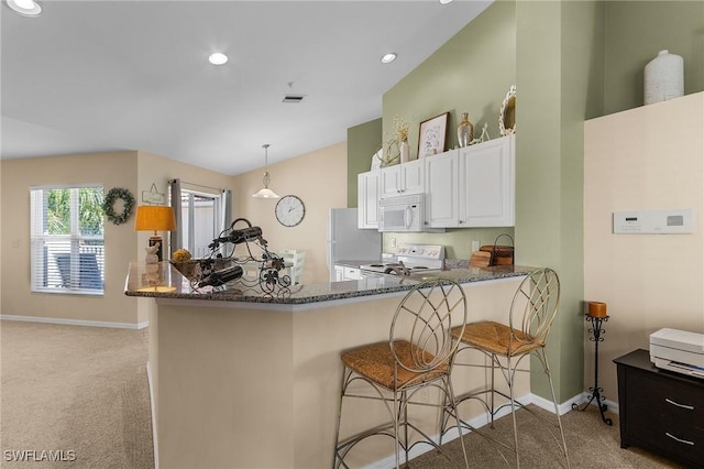 kitchen featuring white cabinetry, kitchen peninsula, pendant lighting, white appliances, and light carpet