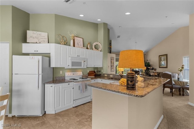 kitchen featuring white appliances, dark stone counters, kitchen peninsula, vaulted ceiling, and white cabinetry