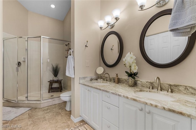 bathroom featuring vanity, toilet, and an enclosed shower