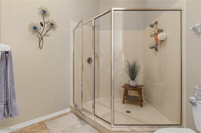 bathroom featuring tile patterned floors, toilet, and walk in shower