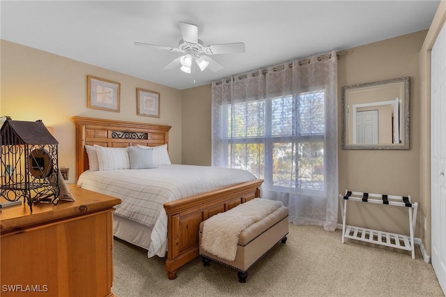 carpeted bedroom with ceiling fan and a closet