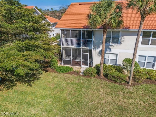 rear view of property with a lawn