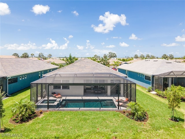 view of swimming pool featuring a yard, a patio, and a lanai