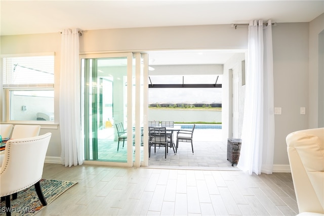 doorway to outside featuring plenty of natural light and a water view