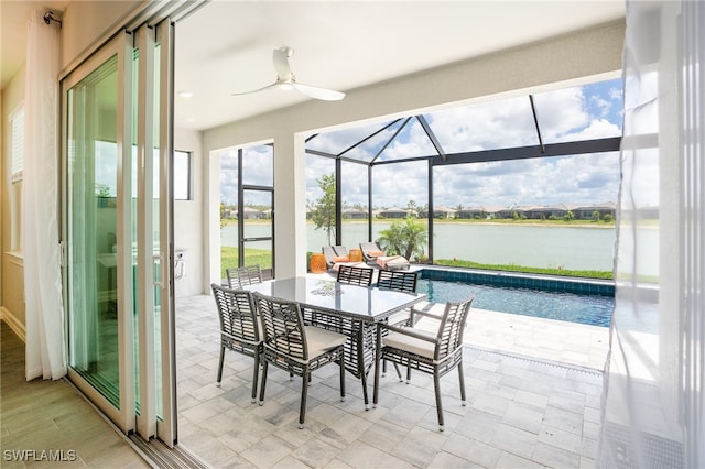 interior space featuring a water view, ceiling fan, and a pool