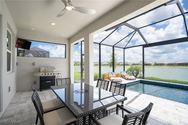 exterior space with a water view, grilling area, a lanai, ceiling fan, and a patio