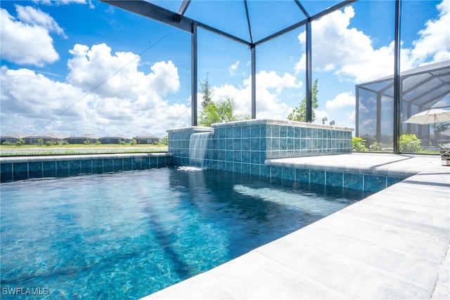 view of pool with pool water feature and a lanai