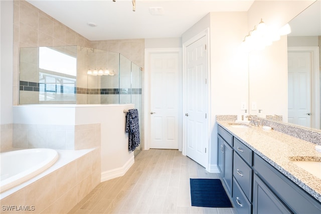 bathroom featuring plus walk in shower and vanity