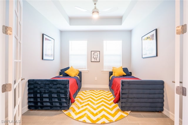 bedroom featuring a tray ceiling and ceiling fan