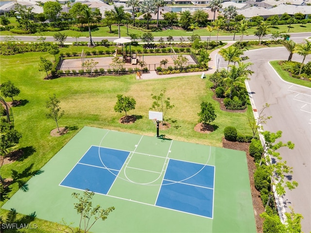 view of basketball court featuring a yard