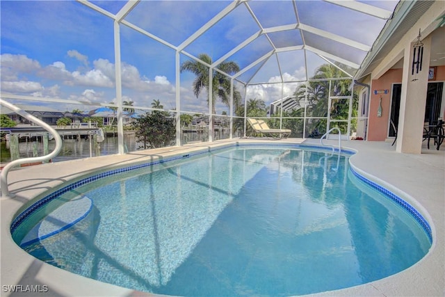 view of pool featuring a water view, glass enclosure, and a patio