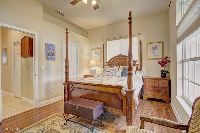 bedroom with light hardwood / wood-style floors and ceiling fan