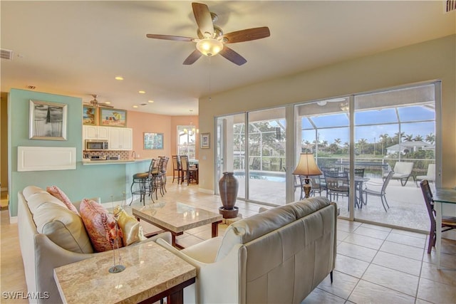 tiled living room with ceiling fan