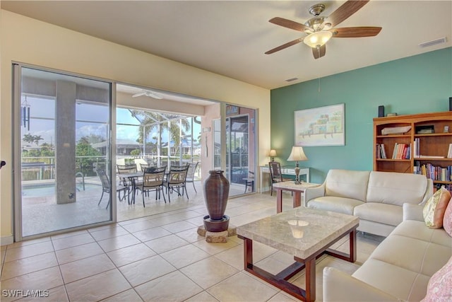 tiled living room with ceiling fan