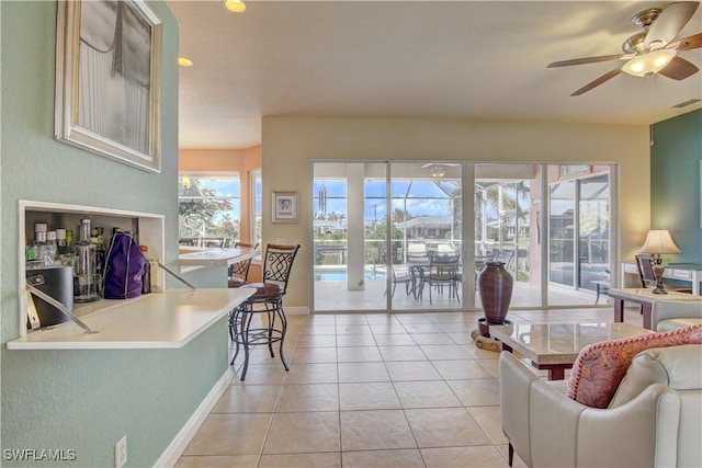 tiled living room with ceiling fan