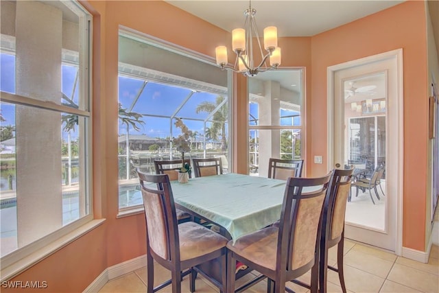 tiled dining space with an inviting chandelier