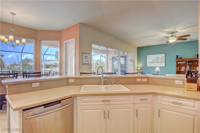 kitchen featuring light tile patterned floors, sink, dishwasher, white cabinets, and ceiling fan with notable chandelier