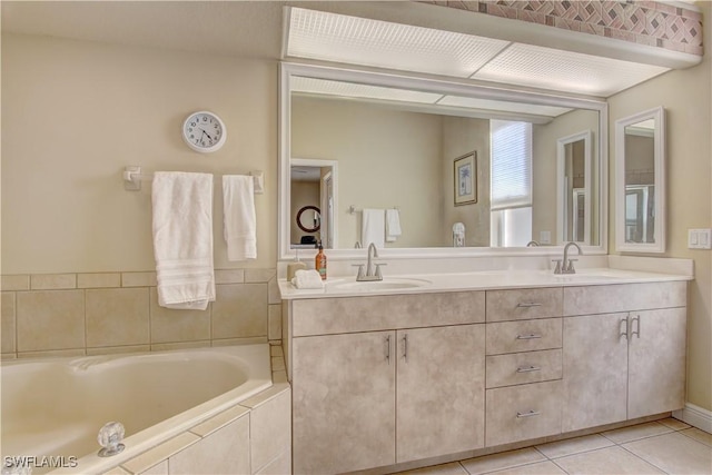 bathroom with vanity, tiled tub, and tile patterned floors