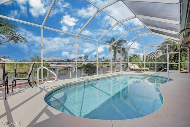 view of swimming pool featuring a boat dock, a patio, a water view, and glass enclosure