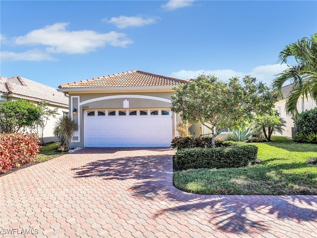 mediterranean / spanish home with a garage