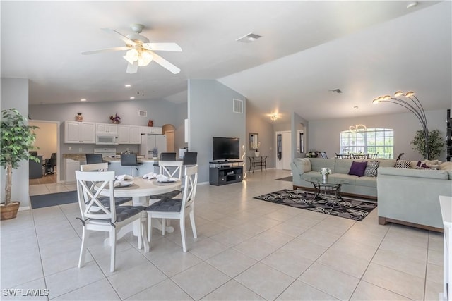 tiled dining space featuring ceiling fan and lofted ceiling