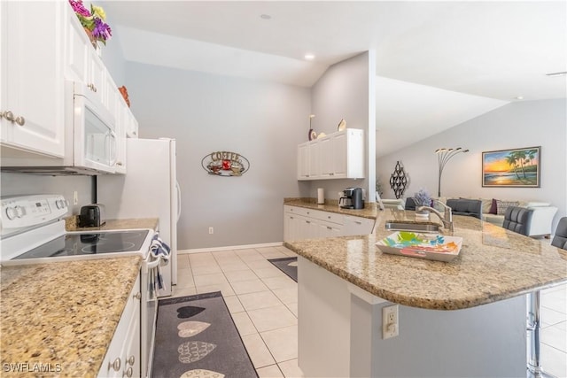 kitchen with white cabinets, a breakfast bar, stainless steel electric range oven, and lofted ceiling