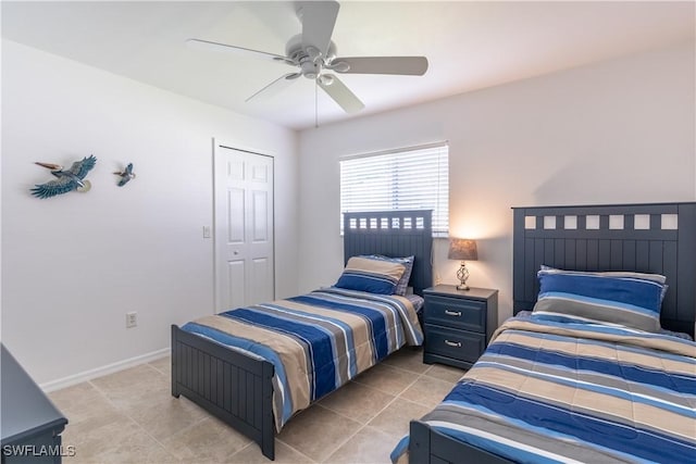 tiled bedroom with a closet and ceiling fan